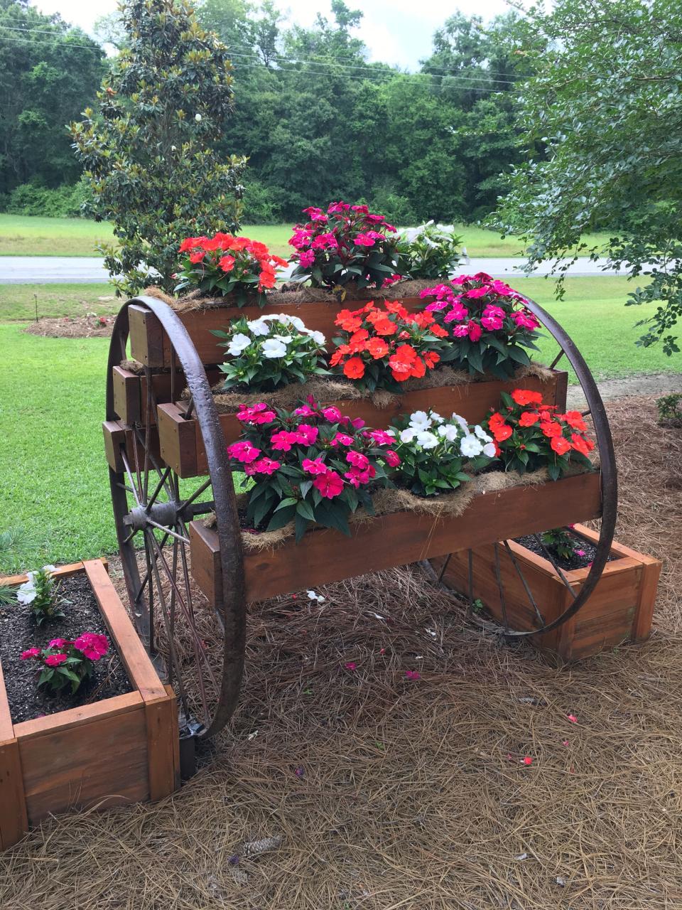 Love my wagon wheel planter built by my husband with idea from